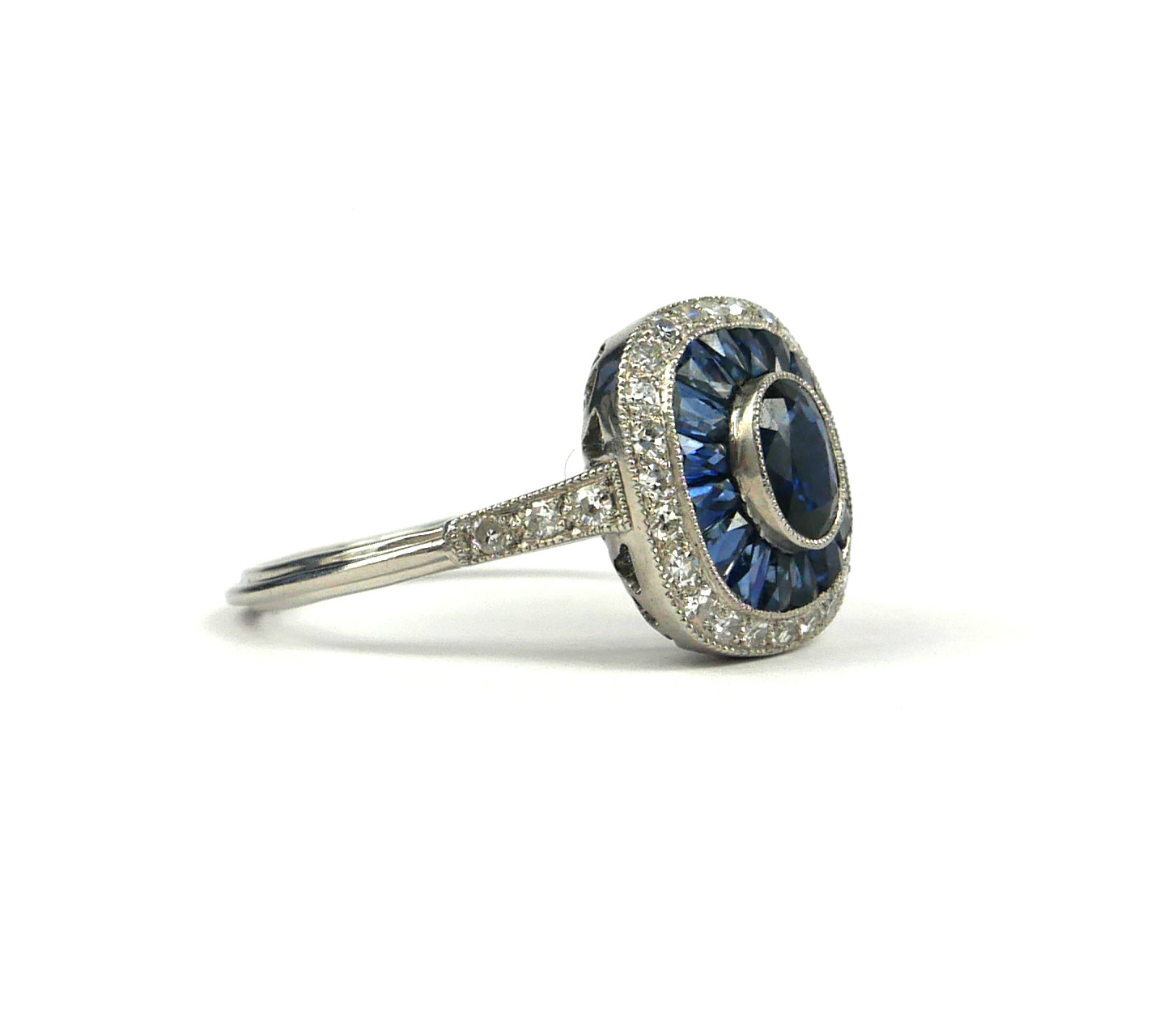 A PLATINUM ART DECO STYLE, SAPPHIRE AND DIAMOND RING. The Centre oval shaped sapphire surrounded - Image 2 of 3