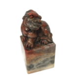 A CHINESE JADE SEAL, surmounted by the figure of a lion dog, character seal to base. H- 6.9cm W-3.