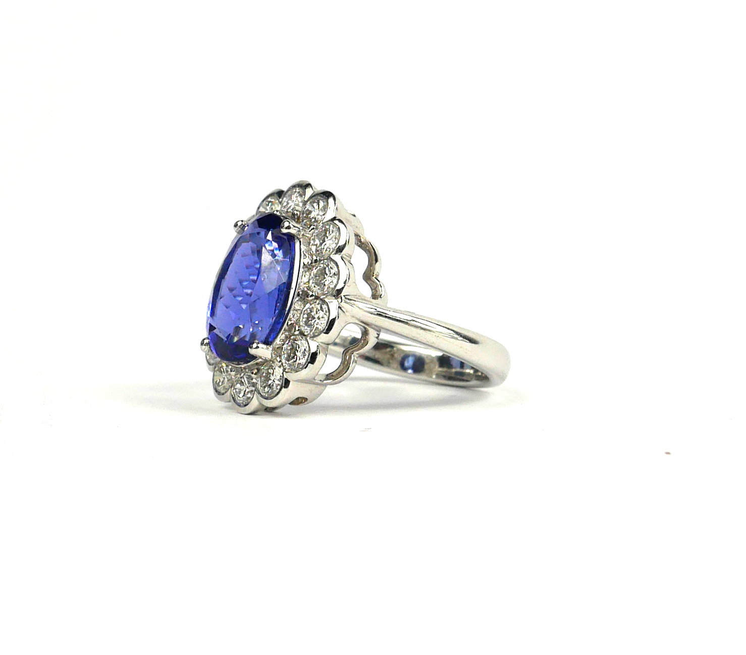 AN 18CT WHITE GOLD OVAL TANZANITE AND DIAMOND CLUSTER RING. (Approx Tanzanite 4.55ct, Diamonds 1. - Image 2 of 3