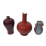 THREE CHINESE RED GLAZED VASES To include a Fang Hu flambe glazed vase and globular oxblood glazed