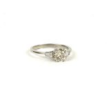 A PLATINUM, ROUND BRILLIANT CUT DIAMOND SOLITAIRE RING WITH BAGUETTE CUT DIAMOND SHOULDERS, with WGI