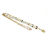 A LATE VICTORIAN YELLOW METAL GRADUATED MULTI-GEMSTONE NECKLACE, TESTED AS 14CT GOLD Gemstones