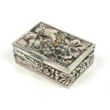 A VINTAGE WHITE METAL RECTANGULAR PILL BOX With embossed decoration of vine leaves and berries. (