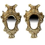 A PAIR OF 18TH CENTURY ITALIAN CARVED GILTWOOD MIRRORS Decorated with facial masks, winged