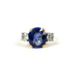 A 9CT WHITE AND YELLOW GOLD LAB GROWN SAPPHIRE RING FLANKED BY TWO DIAMONDS, with WGI