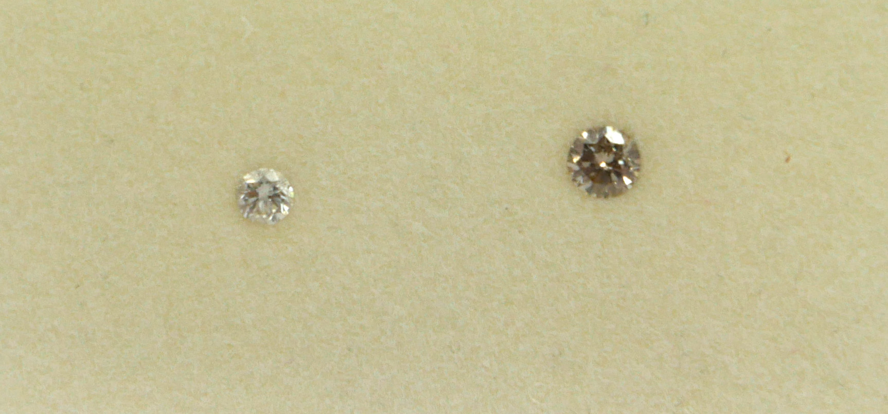 TWO LOOSE UNMOUNTED ROUND BRILLIANT CUT DIAMONDS, boxed. (0.08ct / 0.16ct)