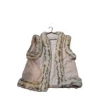 A VINTAGE FAUX LIGHT COLOURED FUR GILET/WAISTCOAT. (approx size 20)