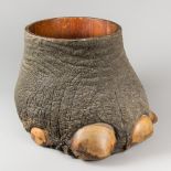 A LATE 19TH CENTURY TAXIDERMY ELEPHANT FOOT CONTAINER. (h 36.5cm x w 57cm x d 40cm)