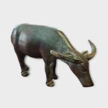 A VINTAGE CHINESE BRONZE BUFFALO Standing pose with elongated horns and verdigris patination. (