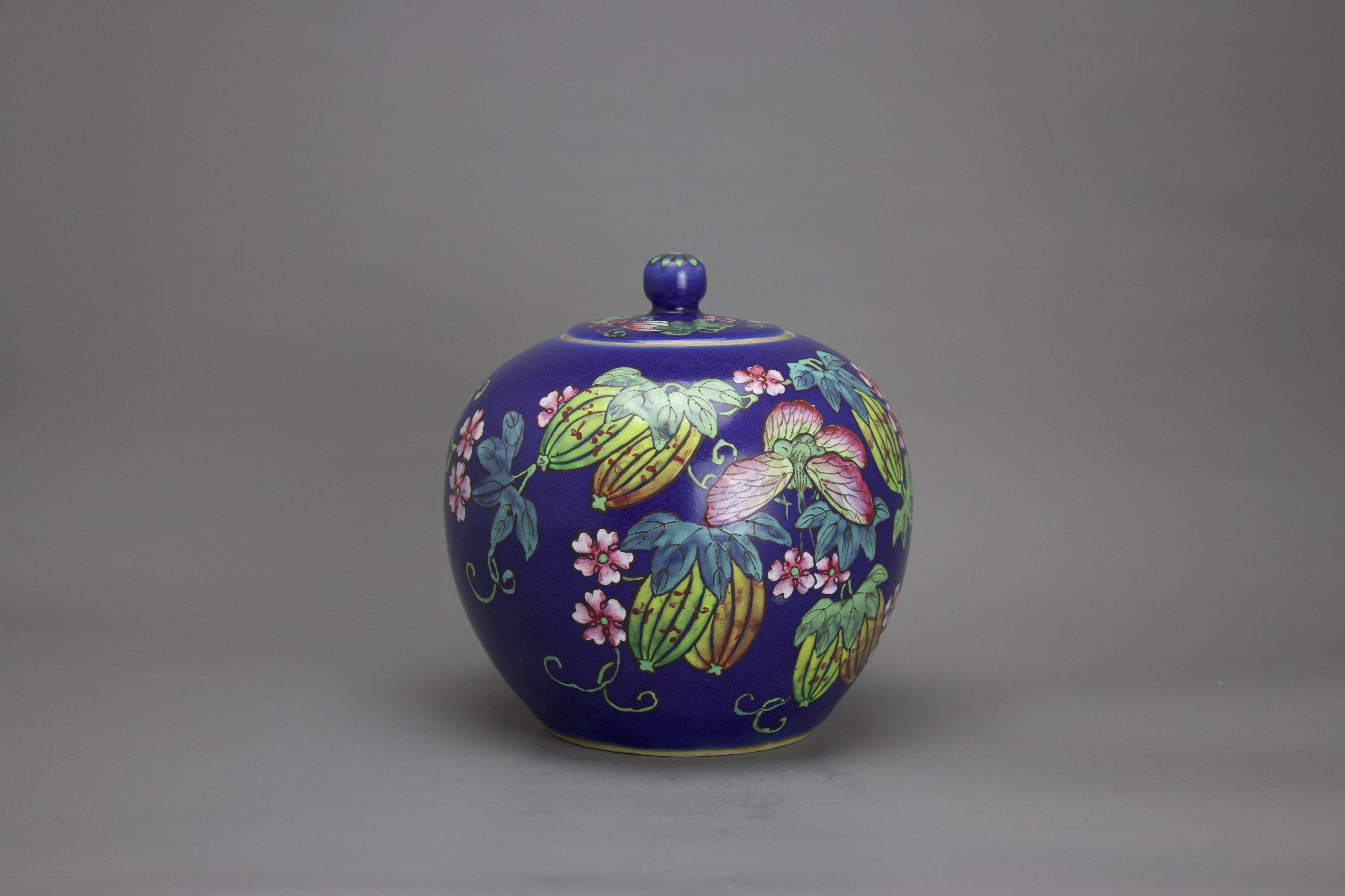 A blue ground 'famille rose' Jar and Cover, c. 1900 H: 19.5cm of globular form, decorated with gourd