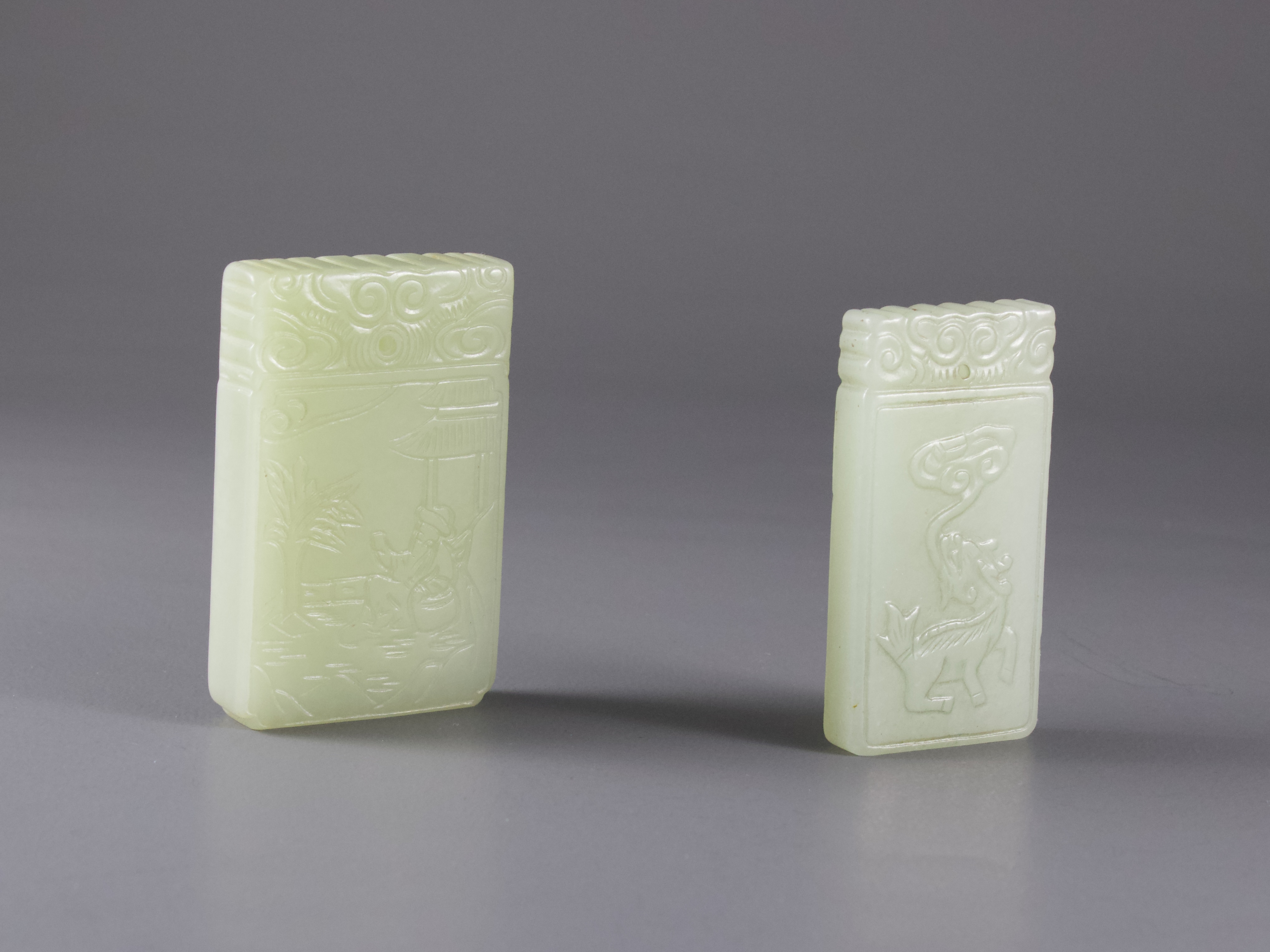 A celadon Jade rectangular Kylin Plaque, and Another, with a sage in a gardenH: 5.2cm and H: 5.5cm