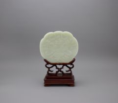 A celadon Jade ruyi shaped Plaque, 19th CenturyW: 14.6cm,H: 12.2cm, wood stand A celadon Jade ruyi