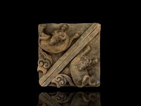 A pair of grey pottery triangular Tiles modelled with Goats, Ming Dynasty L: 26.5cm, W :27cm each