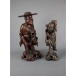 Two oriental wood carved figures, 19th / 20th century. H: 34.5cm The bigger figure depicts a monk