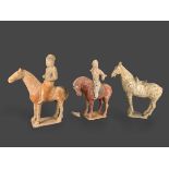 Two pottery Equestrian Groups, and a Saddlled Horse, Tang dynasty(AD 618 - 907) L: 25cm - 28cm, H: