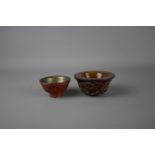 Two Chinese tea cups, 19th / 20th century. H:5cm The bigger, carved cup is decorated with fish,