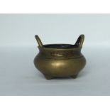 A brass censer, 19th/20th C. H: 6cm Elegantly plain. Two hoop handles. Three nipple shape feet and