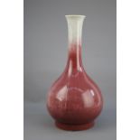 A slender red glazed Bottle Vase, 20th century H: 38.5cm, D: 20.5cm PROPERTY FROM THE COLIN HART