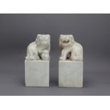 A Pair of Marble Lion Seals, Republic period H: 21cm the crouching beasts with eyes inlaid in black,