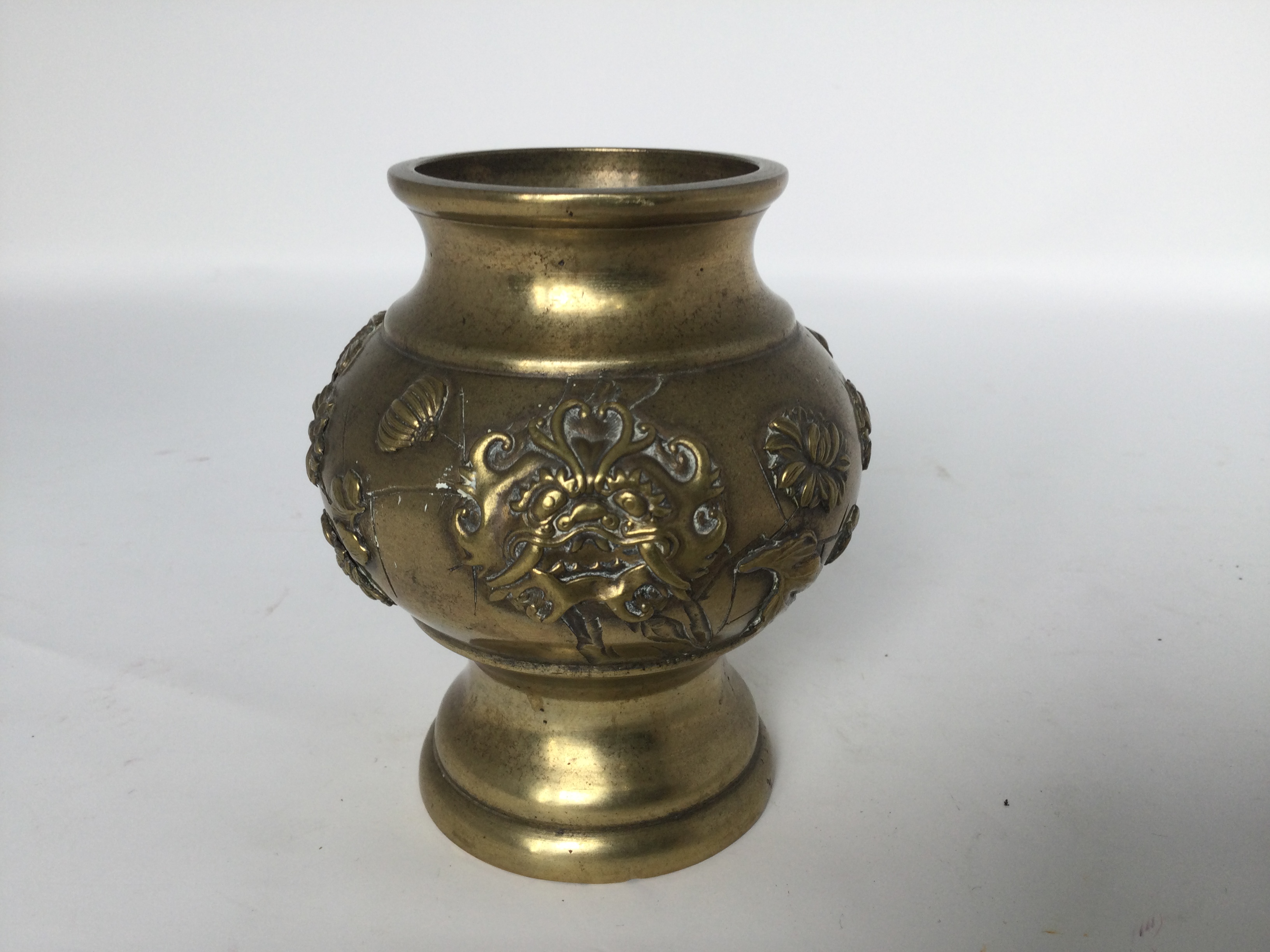 A brass vase, 19th/20th C. H: 10cm The body is decorated with relief of birds, beast masks and