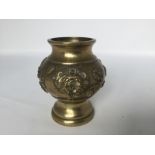 A brass vase, 19th/20th C. H: 10cm The body is decorated with relief of birds, beast masks and