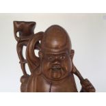 A good Chinese wooden carving , 19th/20th C. H: 47cm A well crafted hard wood smiling Buddha, "Bu