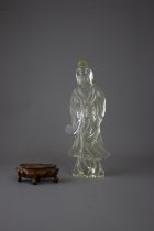 A Rock Crystal standing figure, c 1900H 24cm W 3.5cm'L 9.5cm grasping a flywhisk, wood stand.