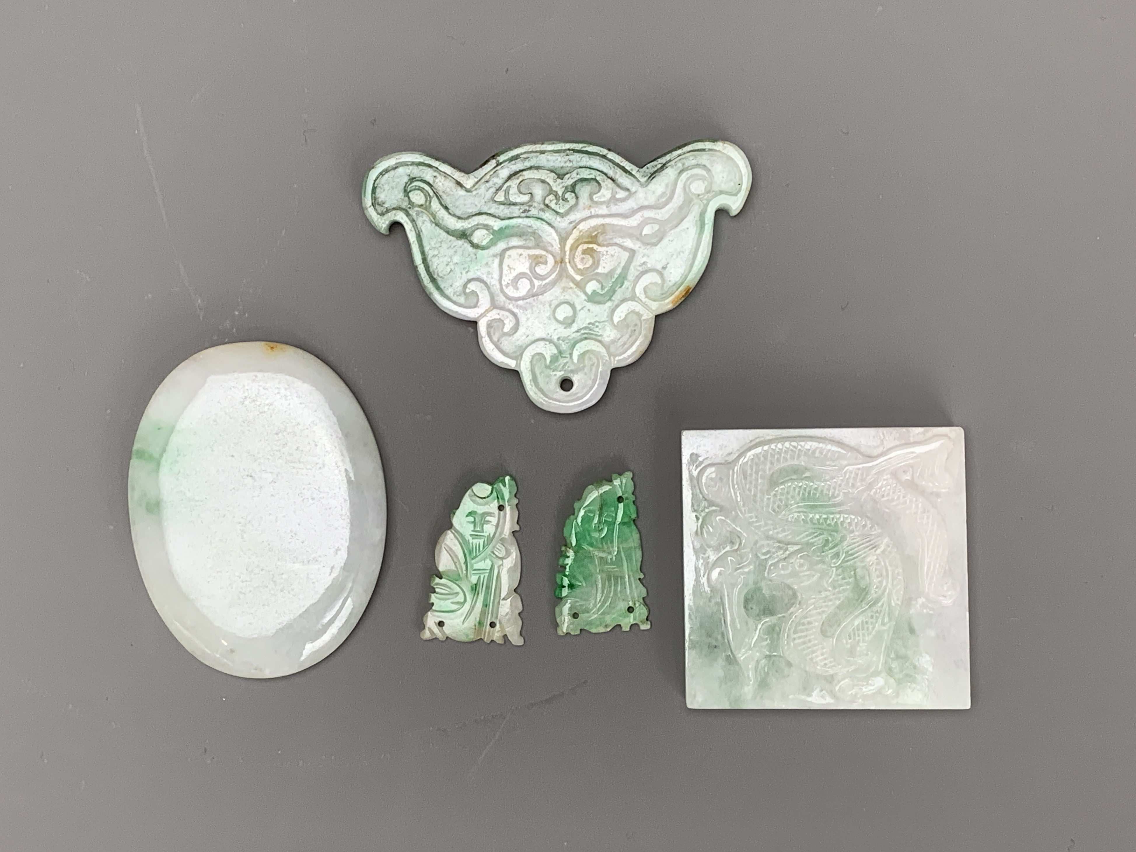 A group of jadeite carvings, c. 1900 From top to bottom, left to right: L 51cm W 47cm L 24cm W 14.