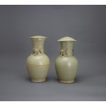 A Pair of olive glazed Jars and Covers, Song/Yuan dynasty the taller H: 25cm, W: 12cm PROPERTY