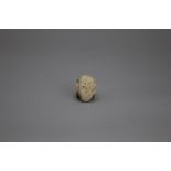 A rare Neolithic grey pottery model of a Human Head, Hongshan culture L: 4cm, W: 3cm PROPERTY FROM