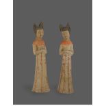 A pair of painted pottery court ladies Tang Dynasty: AD 618 - 907 H: 16.5 cms PROPERTY FROM THE
