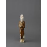 A chestnut glazed pottery tomb figure, Tang Dynasty H:21cm, L:5.5cm The slender moustachioed