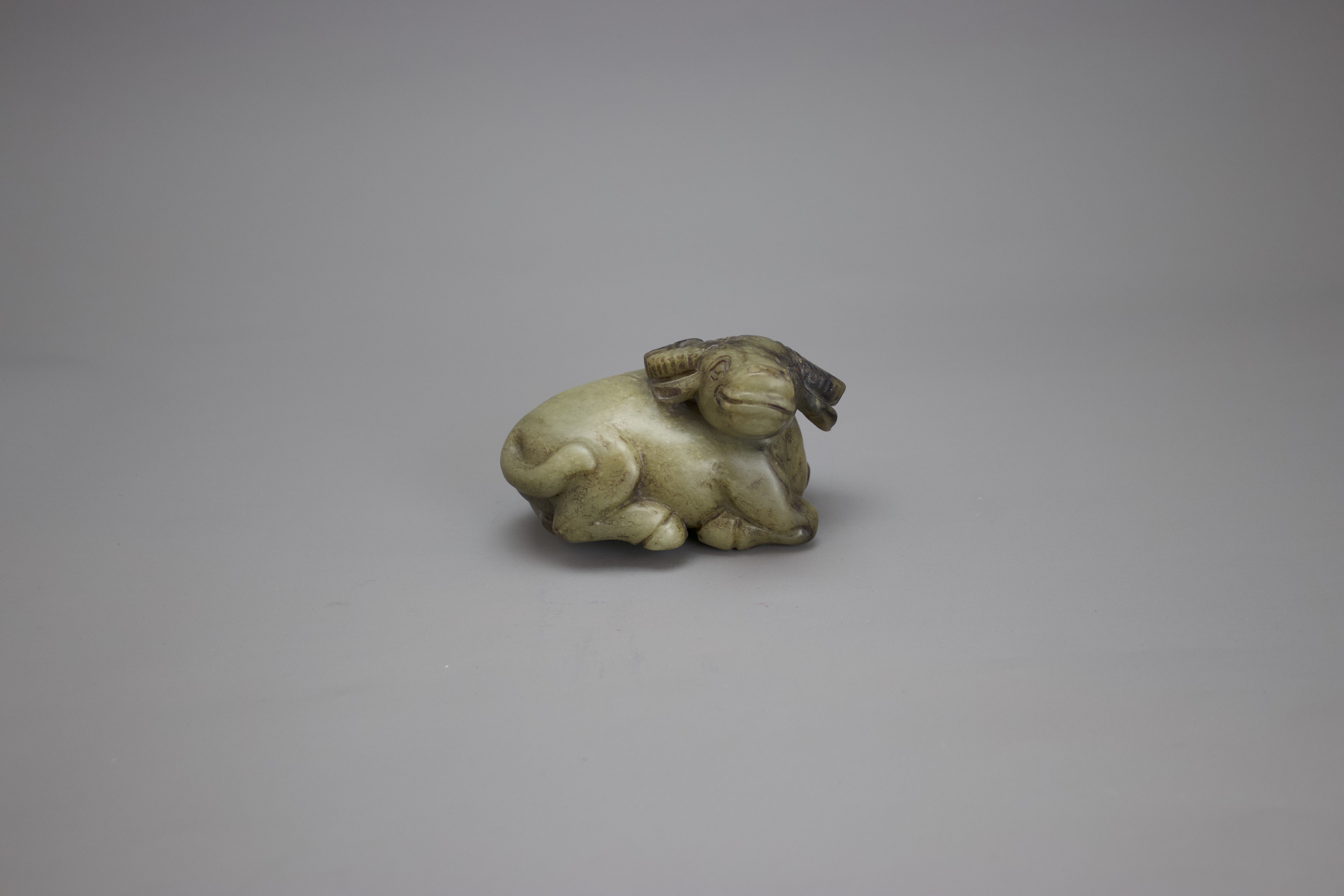 A Jade seated Buffalo, c. 1920 in Ming style H: 5cm w: 9cm A Jade seated Buffalo, c. 1920 in Ming