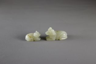 Two small celadon Jade Dogsthe larger L: 4cm Two small celadon Jade Dogs Carved in Yuan style,