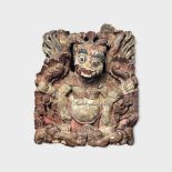 AN EARLY 20TH CENTURY INDONESIAN CARVED WOODEN WALL HANGING Mythical beast with pierced design and