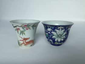 Two famille rose tea cups, 19th/20th C. H: 6.5cm One is decorated with a peach tree and blooms,