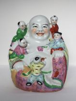 A porcelain Buddha figure, 20th C. H: 26cm A very decorative Buddha, Mi Le Fo, with five children on
