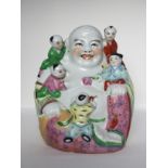 A porcelain Buddha figure, 20th C. H: 26cm A very decorative Buddha, Mi Le Fo, with five children on