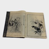A JAPANESE BOOK OF BLACK AND WHITE PRINTS Various traditional images of landscapes and figures. (