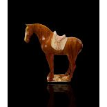 A large amber glazed horse, the glaze of rich deep tone, with moulded saddle and saddle cloth left