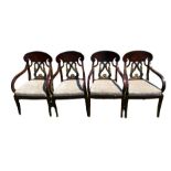 A SET OF FOUR EMPIRE DESIGN MAHOGANY AND PARCEL GILT OPEN ARMCHAIRS With entwined swan back panels