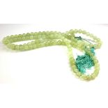 A CHINESE LIGHT GREEN JADE NECKLACE Made with 109 spherical beads, with a dangling turquoise silk