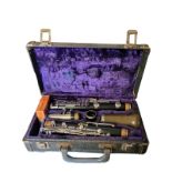 BOOSEY AND HAWKES, A VINTAGE EBONISED CLARINET In five sections with steel mounts, number 77, in a