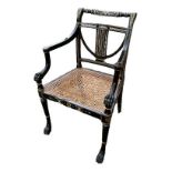A REGENCY STYLE EGYPTIAN REVIVAL OPEN ARMCHAIR With lyre back and lion paw arms above a caned