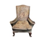 A GEORGIAN DESIGN WING ARMCHAIR In tapestry upholstery, on cabriole legs. (66cm x 64cm x 91cm)