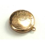 AN EARLY 20TH CENTURY ROLLED GOLD CIRCULAR LOCKET With engraved decoration and hinged interior