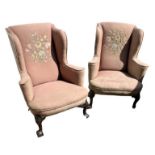 A NEAR PAIR OF 19TH CENTURY GEORGE II DESIGN MAHOGANY AND UPHOLSTERED WINGBACK ARMCHAIRS With padded