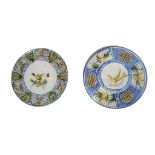 TWO EARLY 20TH CENTURY CONTINENTAL FAIENCE CHARGERS Decorated with birds with floral and fruit
