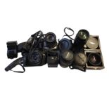A COLLECTION OF CANON SLR CAMERAS AND LENSES Including a Vivitar wide angle fisheye lens, Teleplus
