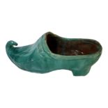 AN EARLY 20TH CENTURY CONTINENTAL NOVELTY EARTHENWARE MODEL OF A CLOG Covered with light green